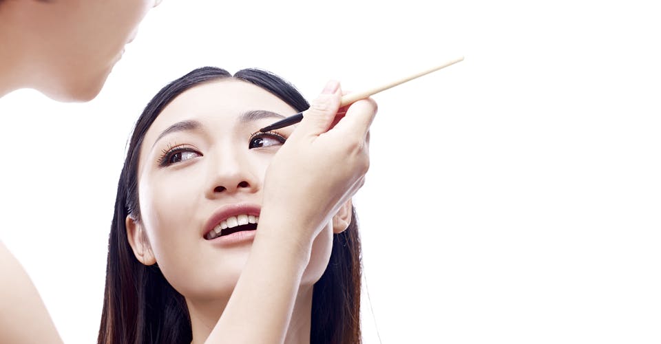 makeup artist applying makeup on a client